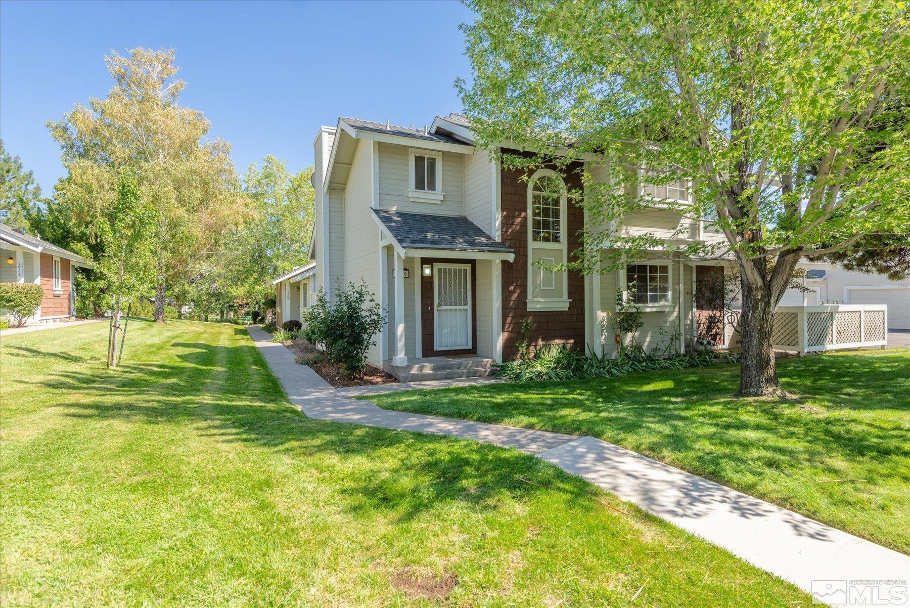1910 Tuolumne Drive Reno, NV 89523 - Photo 1 of 36 a view of a big yard in front of a brick house with a large tree