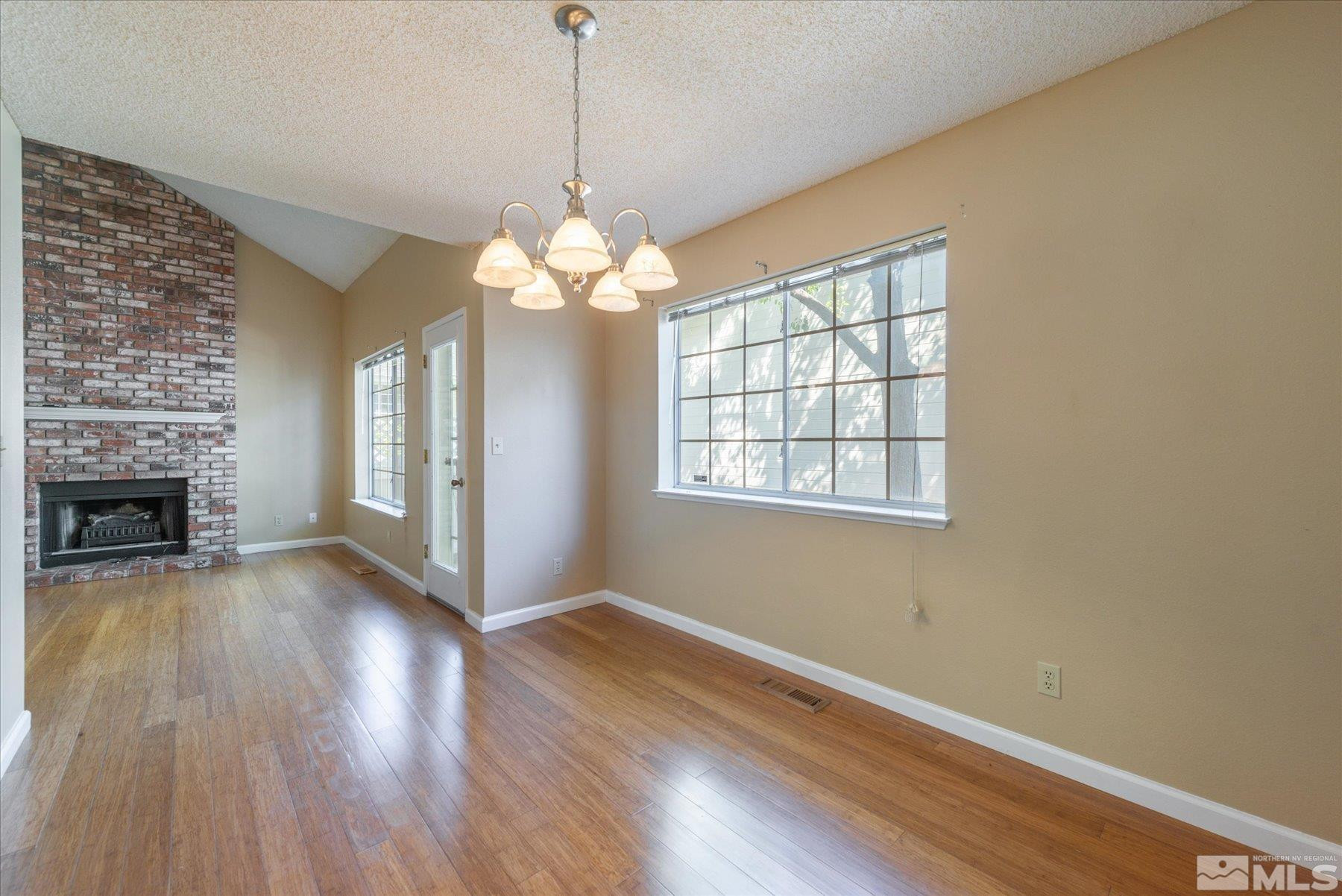 1910 Tuolumne Drive Reno, NV 89523 - Photo 16 of 36 a view of an empty room with wooden floor fireplace and a window