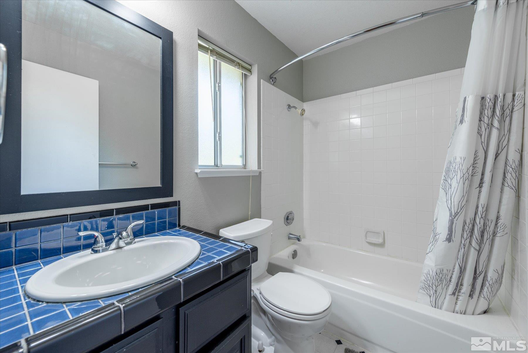 1910 Tuolumne Drive Reno, NV 89523 - Photo 21 of 36 a bathroom with a sink toilet a mirror and shower