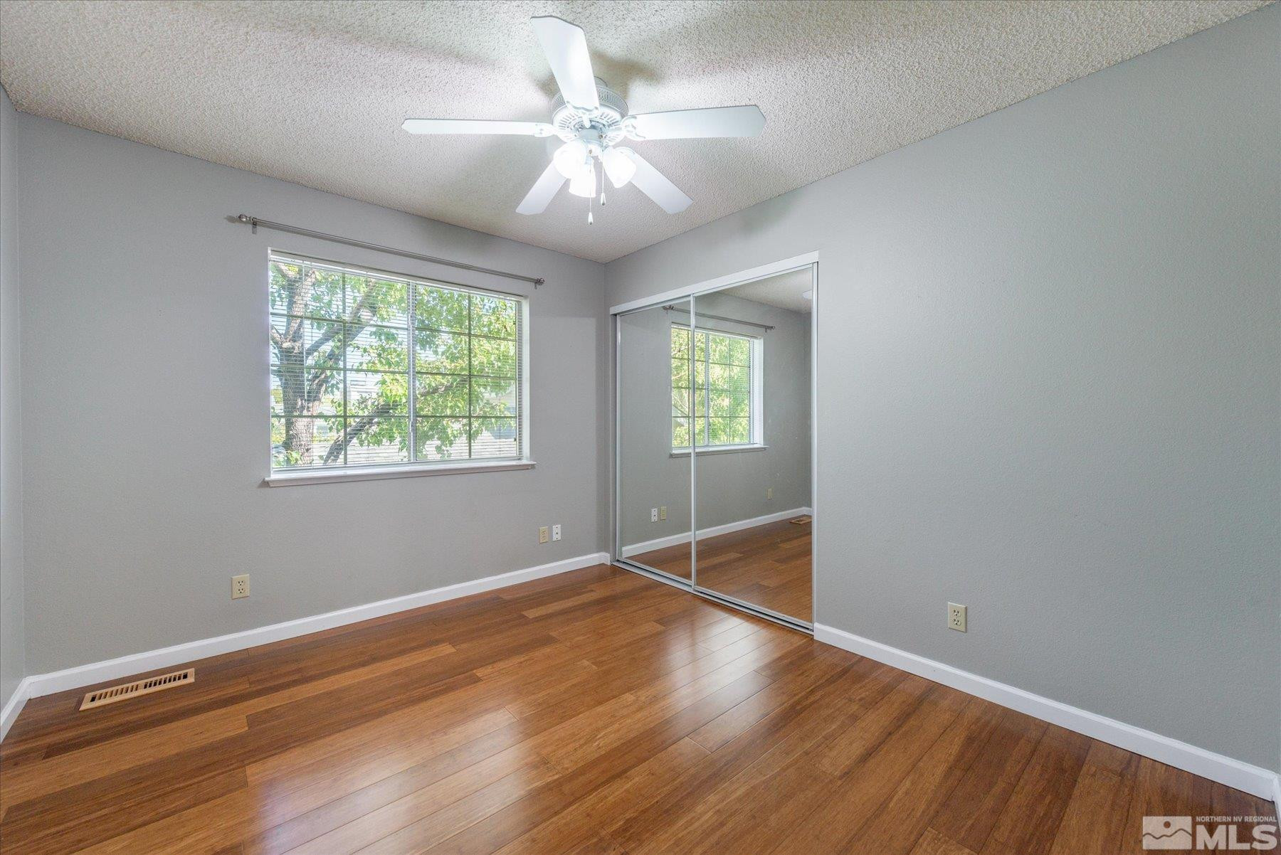 1910 Tuolumne Drive Reno, NV 89523 - Photo 23 of 36 a view of an empty room with wooden floor and a window
