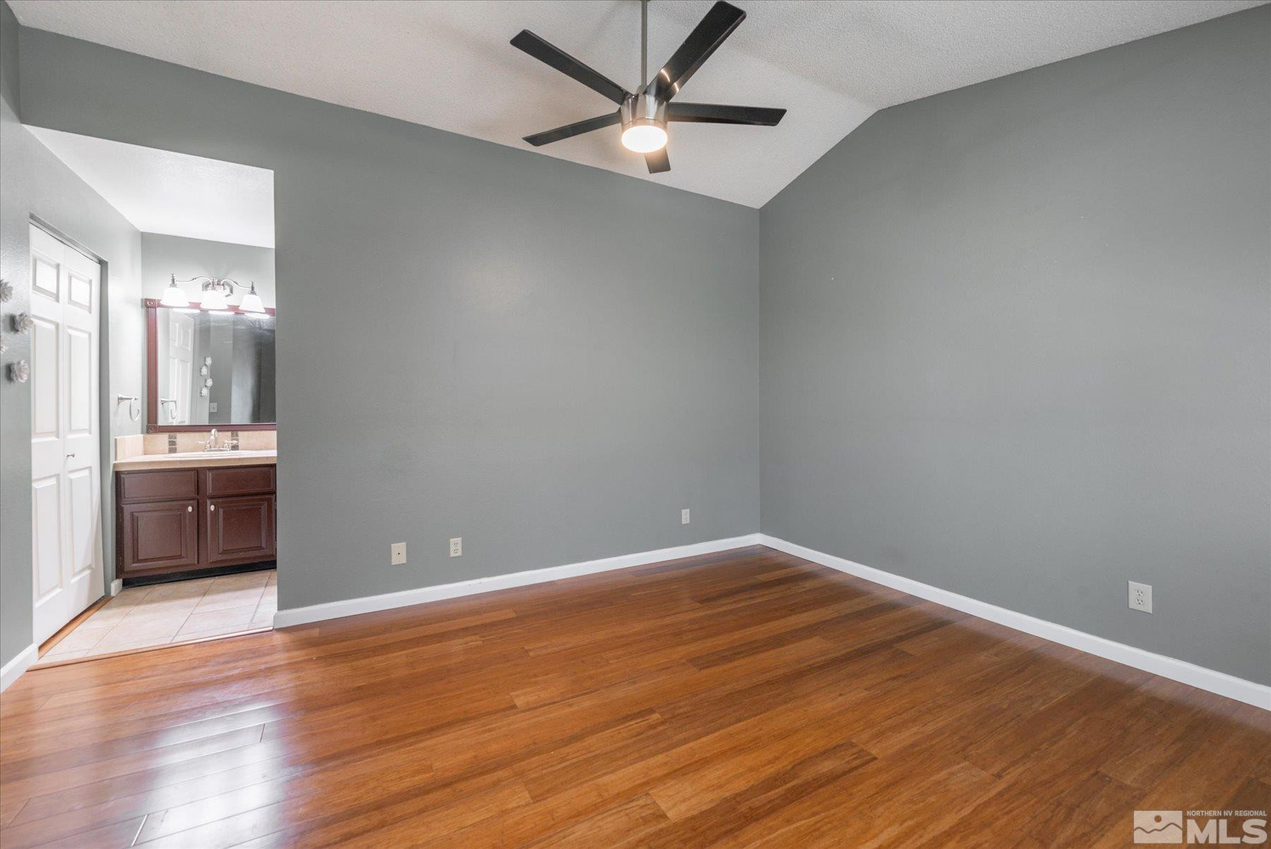 1910 Tuolumne Drive Reno, NV 89523 - Photo 25 of 36 an empty room with wooden floor and a ceiling fan