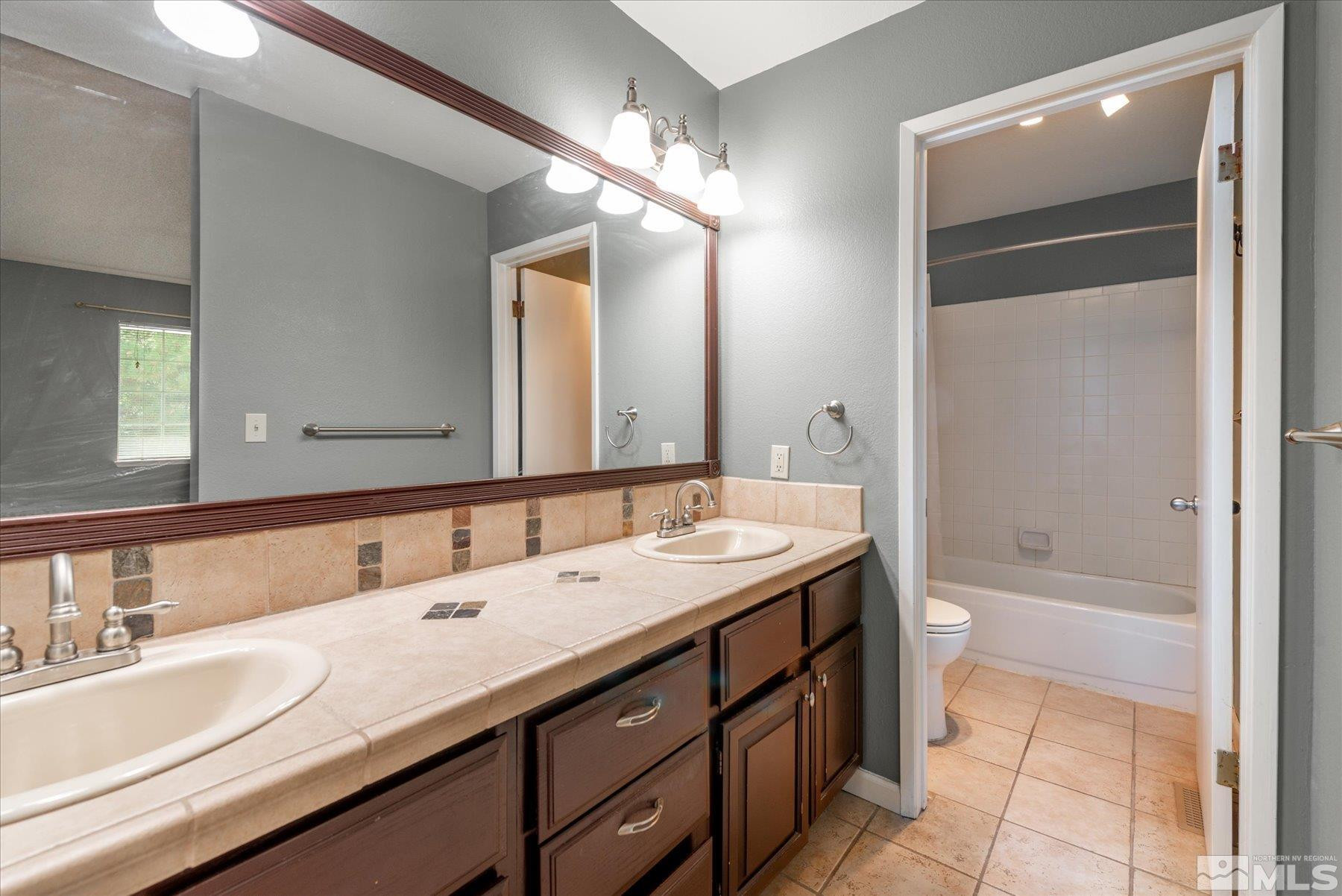 1910 Tuolumne Drive Reno, NV 89523 - Photo 27 of 36 a bathroom with a tub a sink and a mirror