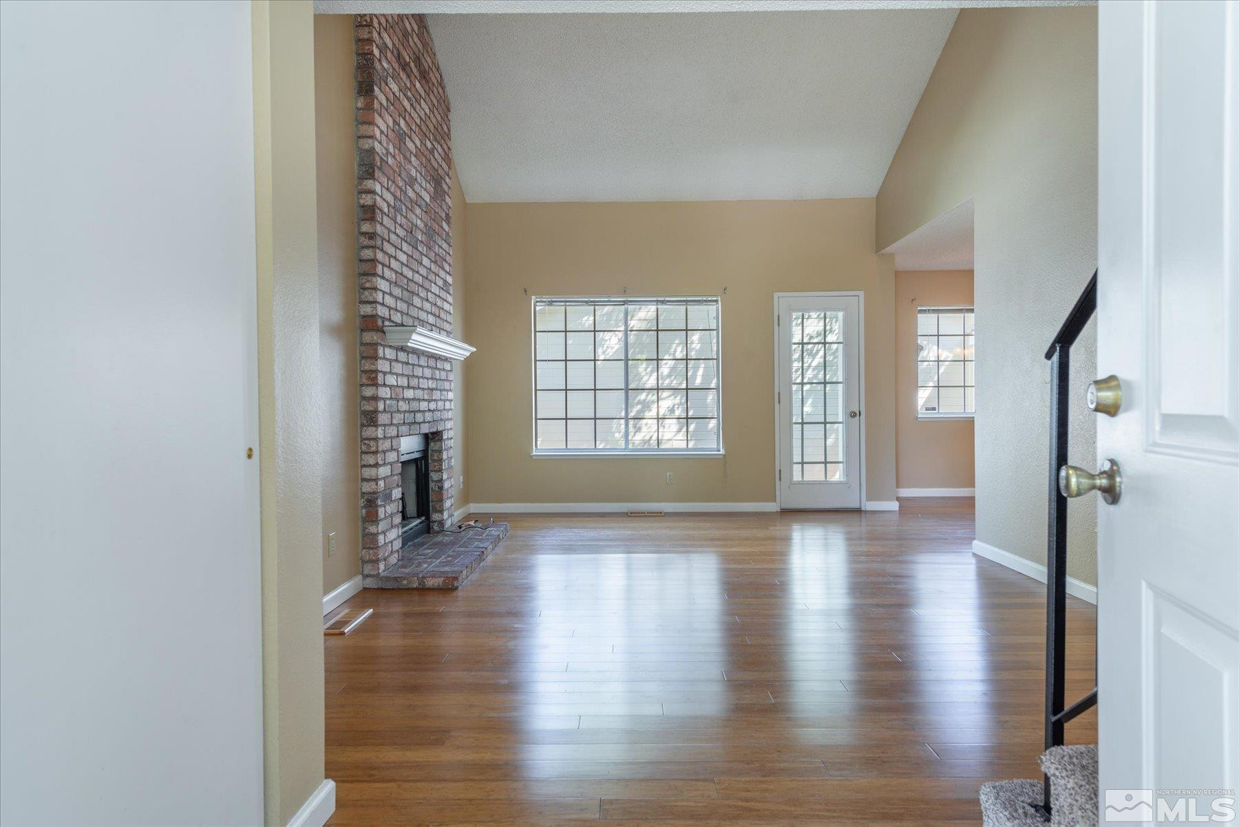 1910 Tuolumne Drive Reno, NV 89523 - Photo 6 of 36 a view of an empty room with a window and wooden floor
