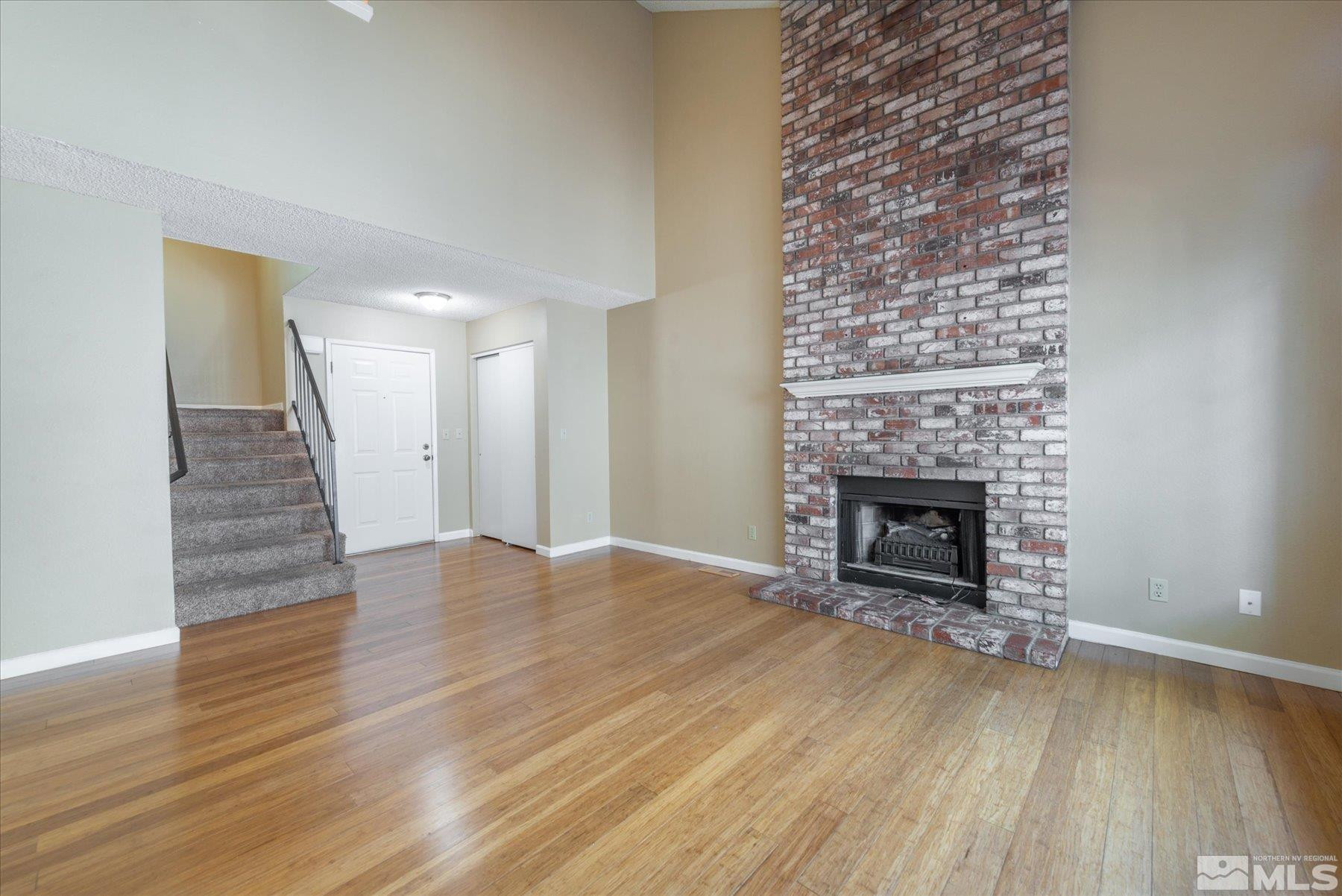 1910 Tuolumne Drive Reno, NV 89523 - Photo 7 of 36 a view of an empty room with wooden floor fireplace and a window