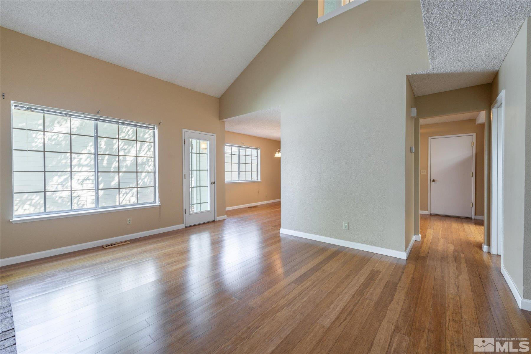 1910 Tuolumne Drive Reno, NV 89523 - Photo 9 of 36 wooden floor in an empty room with a window