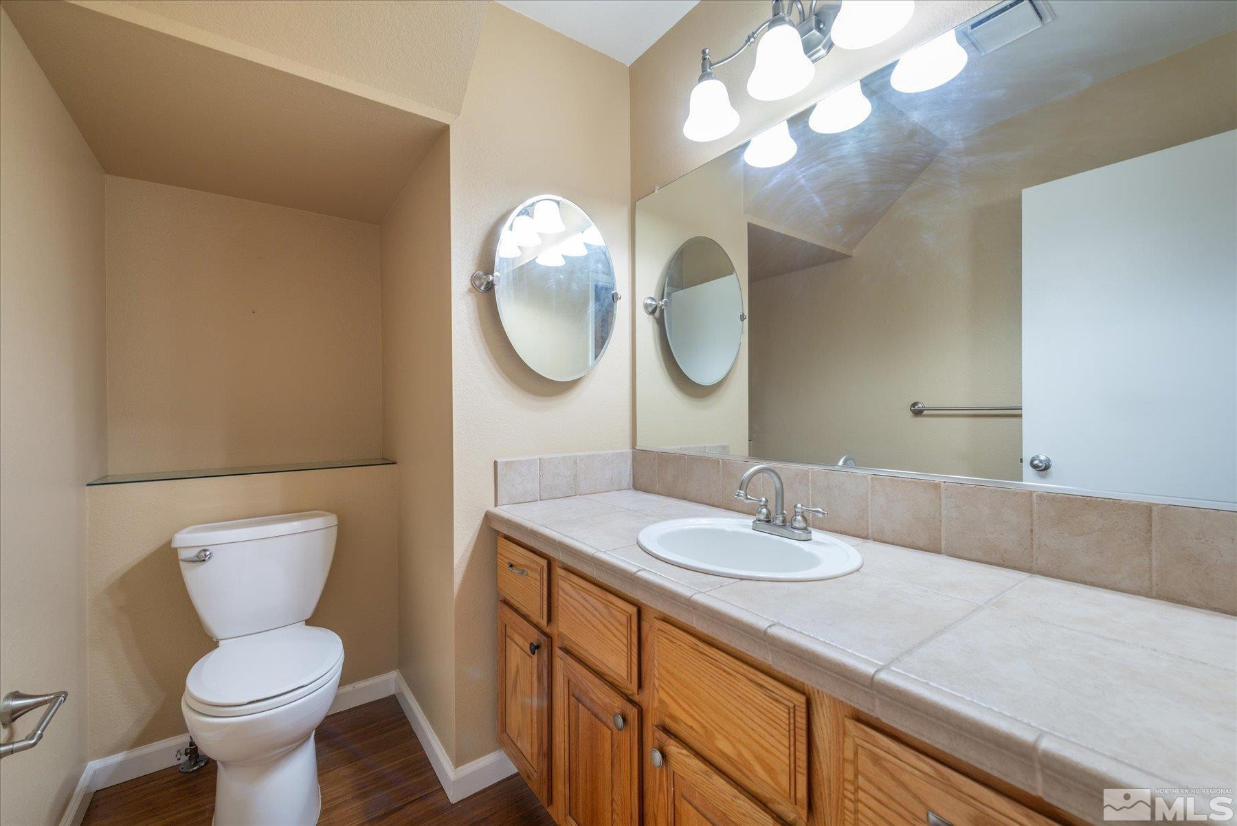 1910 Tuolumne Drive Reno, NV 89523 - Photo 10 of 36 a bathroom with a toilet sink and mirror