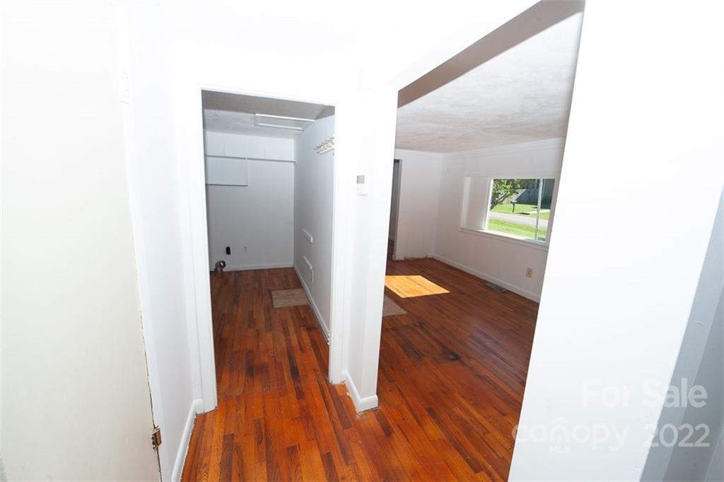 105 Smith Graveyard Road Asheville, NC 28806 - Photo 14 of 16 a view of a hallway with wooden floor and a bathroom