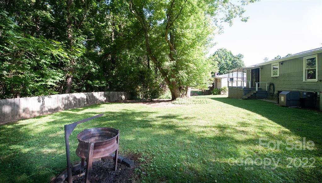 105 Smith Graveyard Road Asheville, NC 28806 - Photo 4 of 16 a backyard of a house with table and chairs