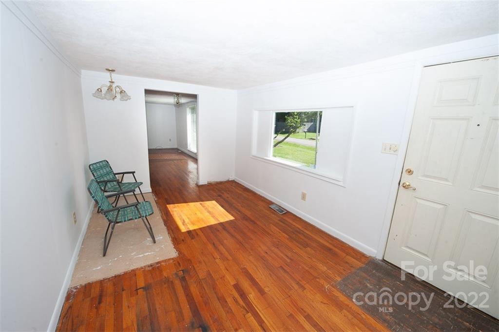 105 Smith Graveyard Road Asheville, NC 28806 - Photo 5 of 16 a workspace with furniture and a wooden floor