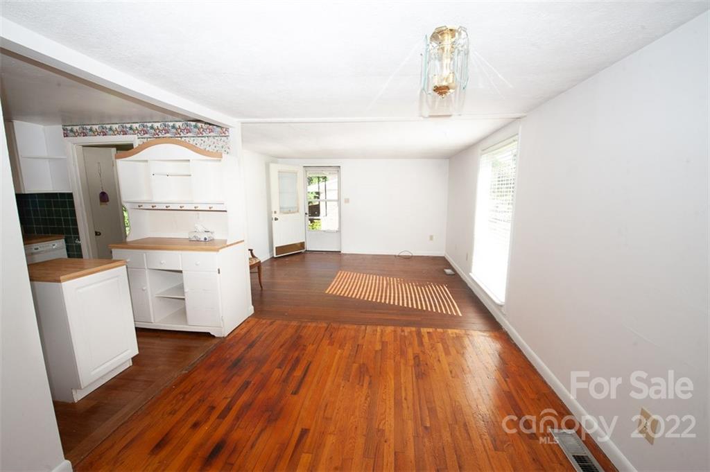 105 Smith Graveyard Road Asheville, NC 28806 - Photo 6 of 16 a view of a kitchen with wooden floor and electronic appliances