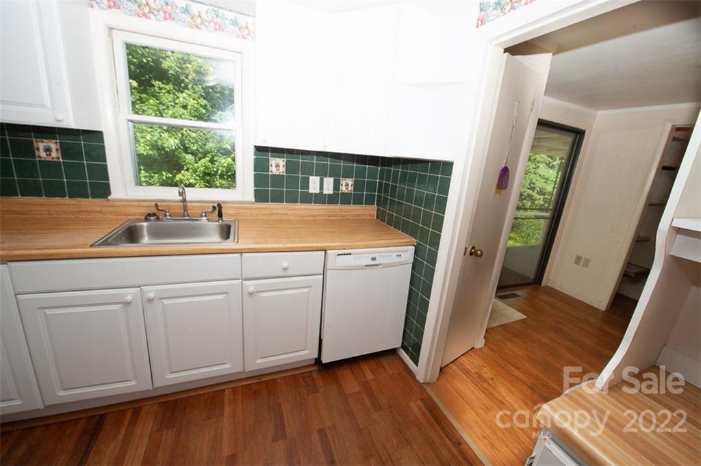 105 Smith Graveyard Road Asheville, NC 28806 - Photo 7 of 16 a kitchen with a sink and wooden floors