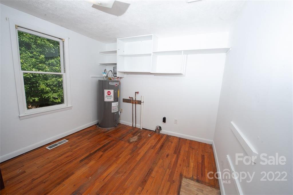 105 Smith Graveyard Road Asheville, NC 28806 - Photo 10 of 16 a view of a room with wooden floor and a window