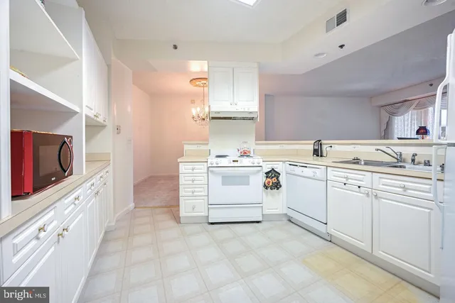 a utility room with cabinets washer and dryer