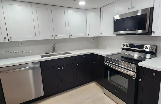 a kitchen with a sink and cabinets