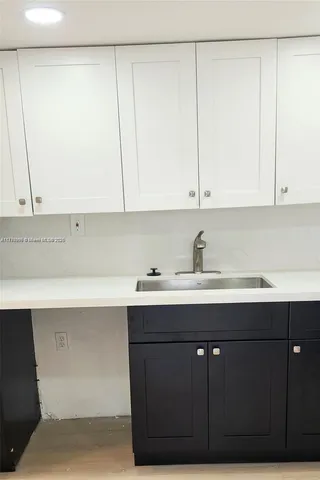 a kitchen with a sink and cabinets