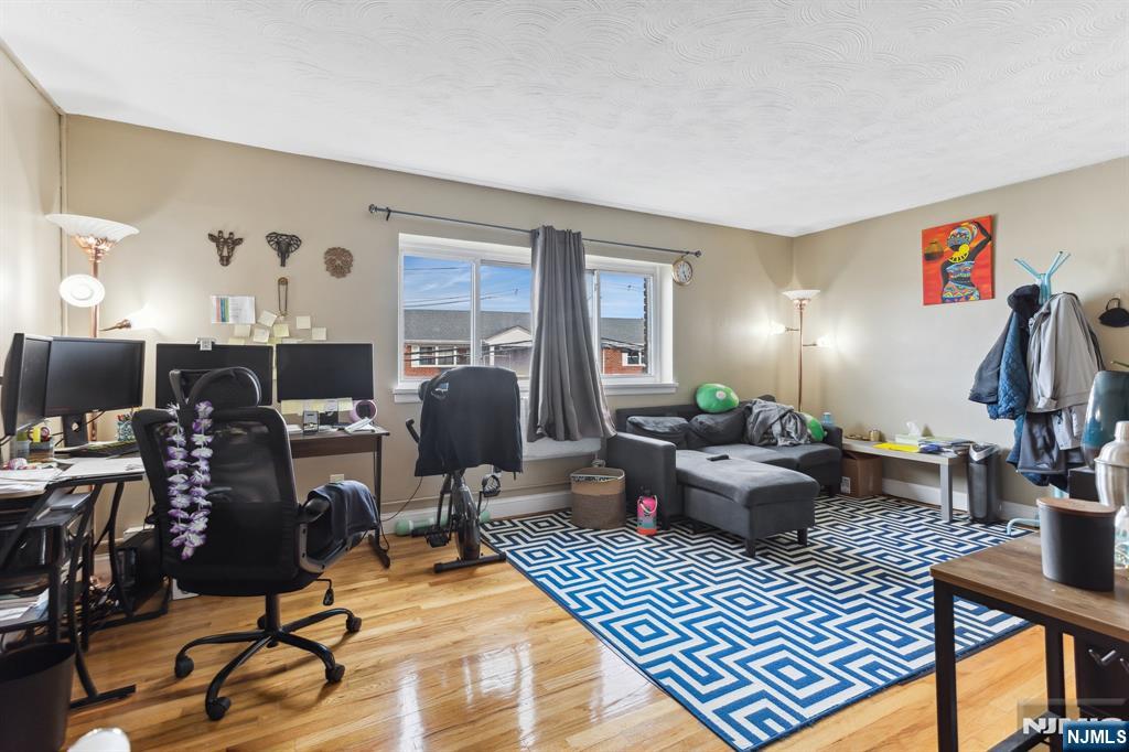 207 Polifly Road, Unit 2074 Hackensack, NJ 07601 - Photo 1 of 15 a living room with furniture a rug and a flat screen tv