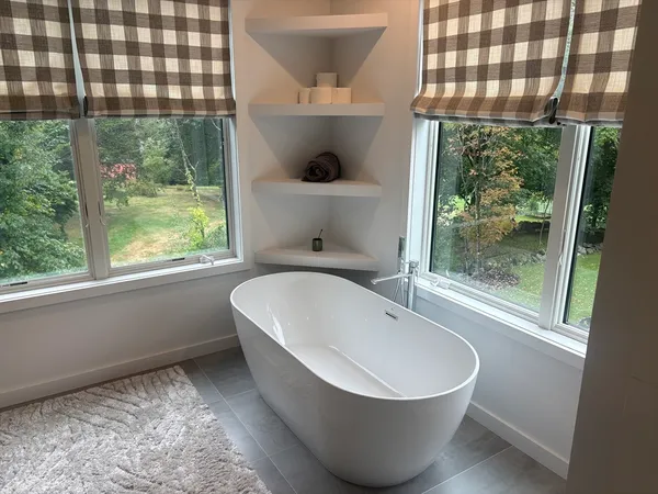 a bathroom with a bathtub and window