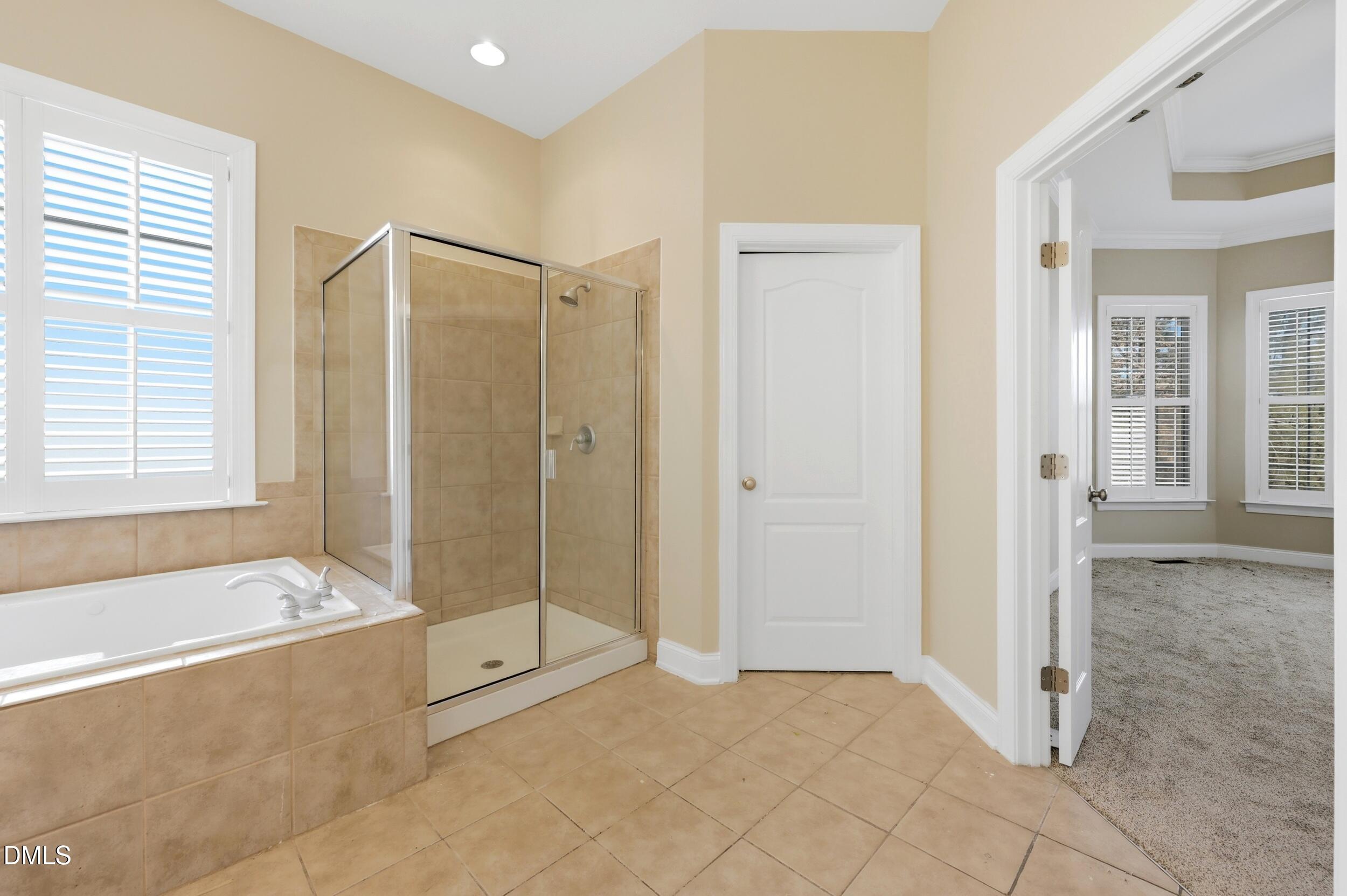 4803 Marena Place Durham, NC 27707 - Photo 16 of 42 a spacious bathroom with a tub shower and window