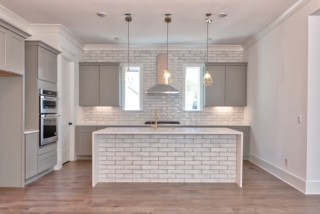a view of kitchen with granite countertop stainless steel appliances and a chandelier