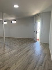 681 Millbury Street Worcester, MA 01607 - Photo 14 of 18 an empty room with wooden floor and windows