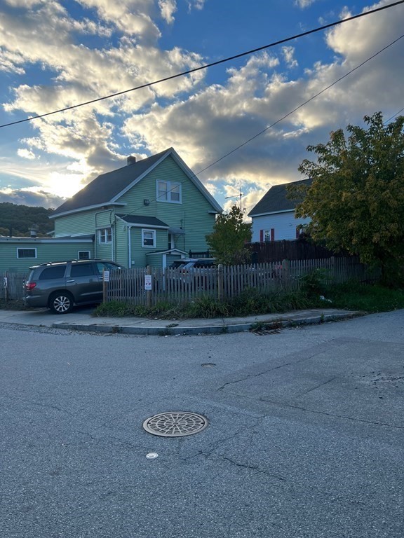 681 Millbury Street Worcester, MA 01607 - Photo 3 of 18 a car parked in front of a house