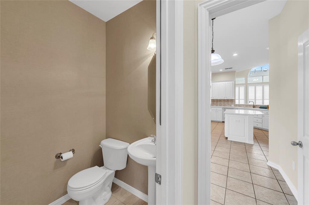 3920 Autumn Lane Bedford, TX 76021 - Photo 15 of 36 Powder room featuring a pedestal sink and wall-mounted light fixture