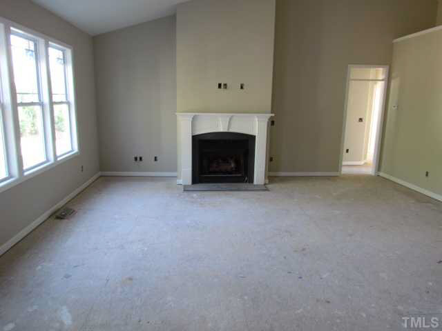 4221 Prelude Street Raleigh, NC 27616 - Photo 11 of 21 Large living room with gas log fireplace, ceiling fan w/ light and carpet w/ 6 lb pad