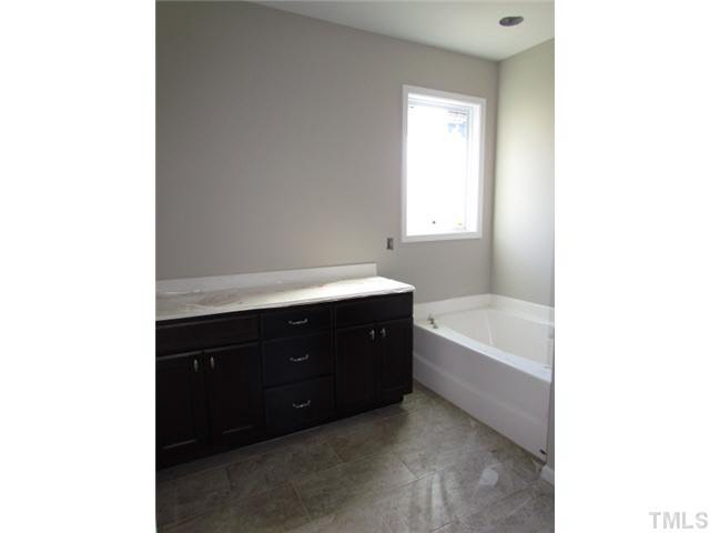 4221 Prelude Street Raleigh, NC 27616 - Photo 16 of 21 Master bath with TILE floor, double vanity, garden tub, shower w/ glass door, his/her closets