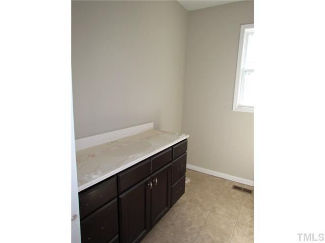 4221 Prelude Street Raleigh, NC 27616 - Photo 20 of 21 Hall bathroom w/ large vanity, full width mirror, vanity light
