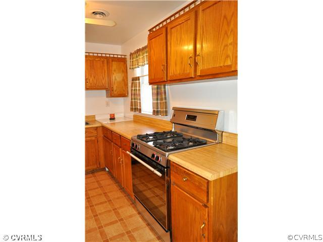 2324 Coxendale Road Chester, VA 23831 - Photo 8 of 18 a kitchen with a stove and a microwave