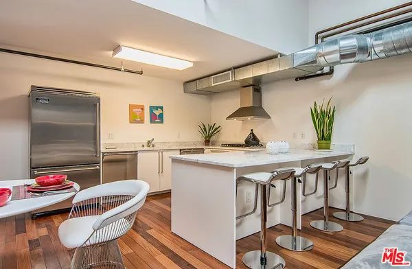 a kitchen with a dining table and chairs