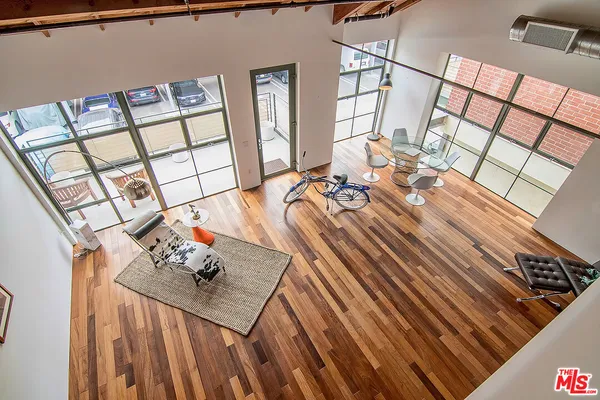 a view of a living room with furniture and a floor to ceiling window