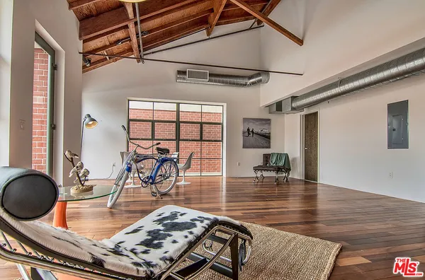 a room with lots of furniture and wooden floor