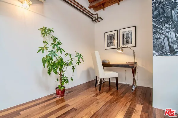 a workspace with furniture and a potted plant
