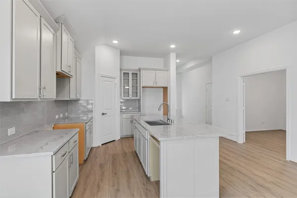 a kitchen with stainless steel appliances granite countertop a sink stove and cabinets