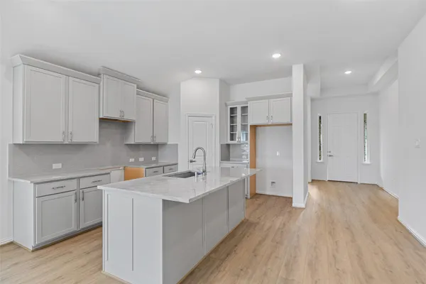 a kitchen with stainless steel appliances refrigerator sink and cabinets