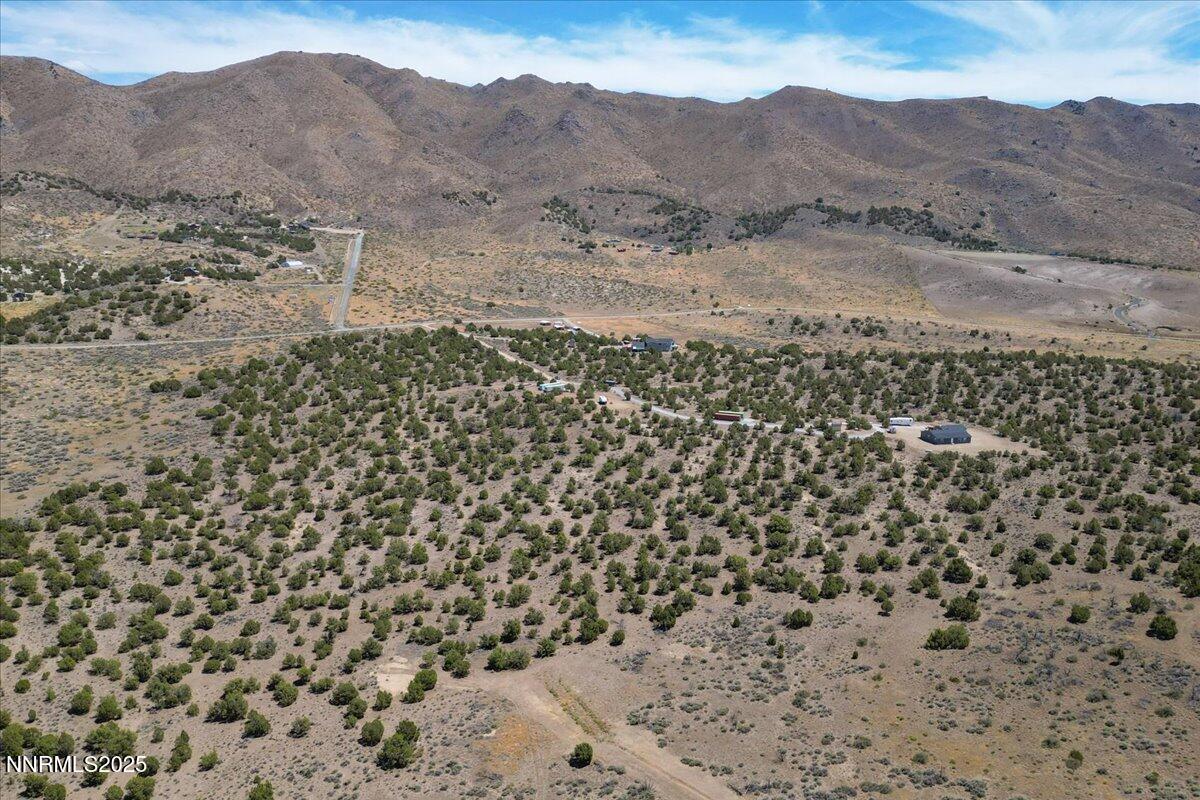 1025 Wendell Lane Reno, NV 89508 - Photo 6 of 21 a view of a dry yard with mountains in the background