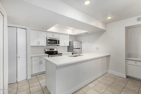 a kitchen that has a sink and a stove top oven