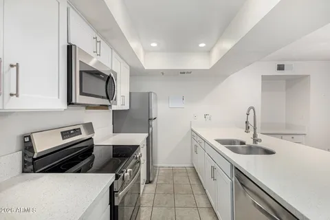 a kitchen that has a sink and a stove