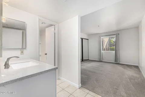 a bathroom with a granite countertop sink and a mirror