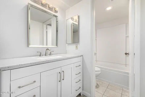 a white bath tub sitting next to a toilet