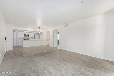 a view of a kitchen with white cabinets and wooden floor