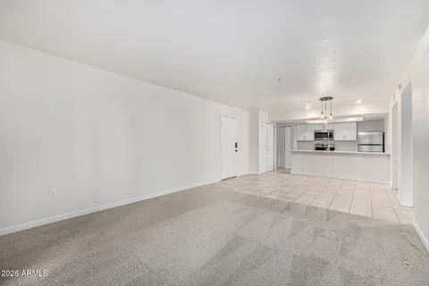 a view of a kitchen with white cabinets