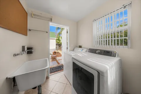 a room with a bed and a chair with the wooden floor