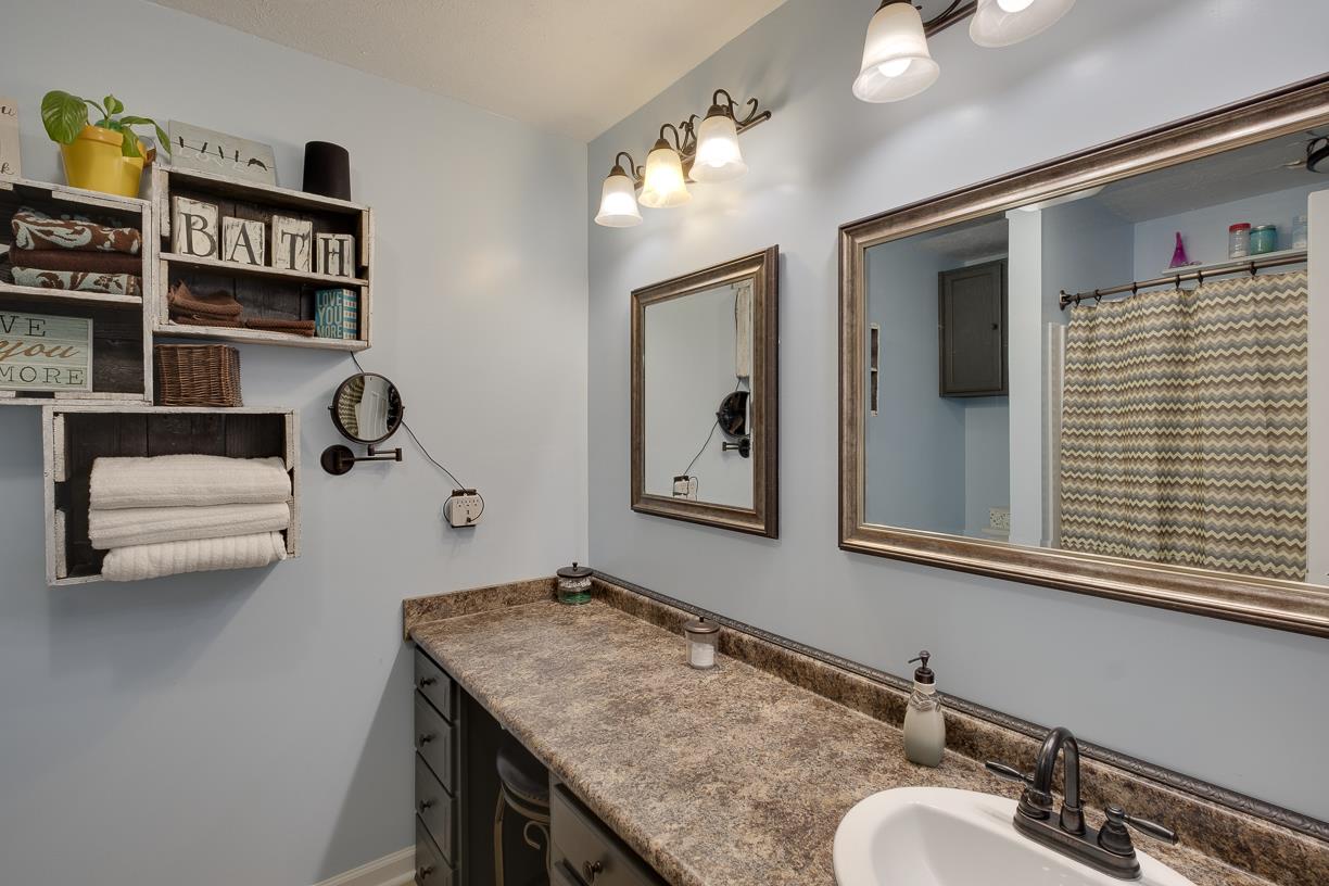 203 Link Road Cottontown, TN 37048 - Photo 13 of 30 a bathroom with a granite countertop sink and a mirror