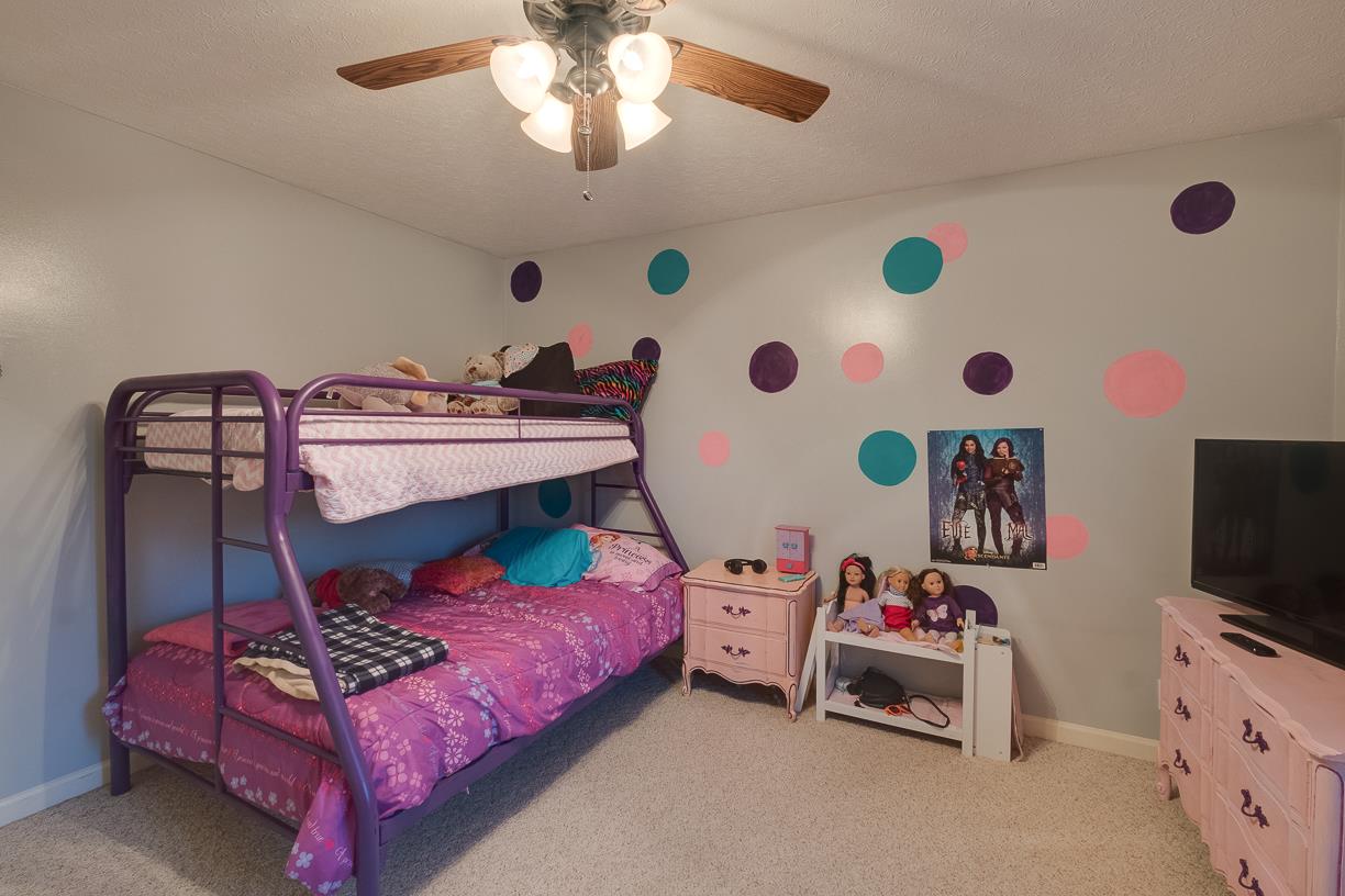 203 Link Road Cottontown, TN 37048 - Photo 16 of 30 a bedroom with a bed and a chandelier
