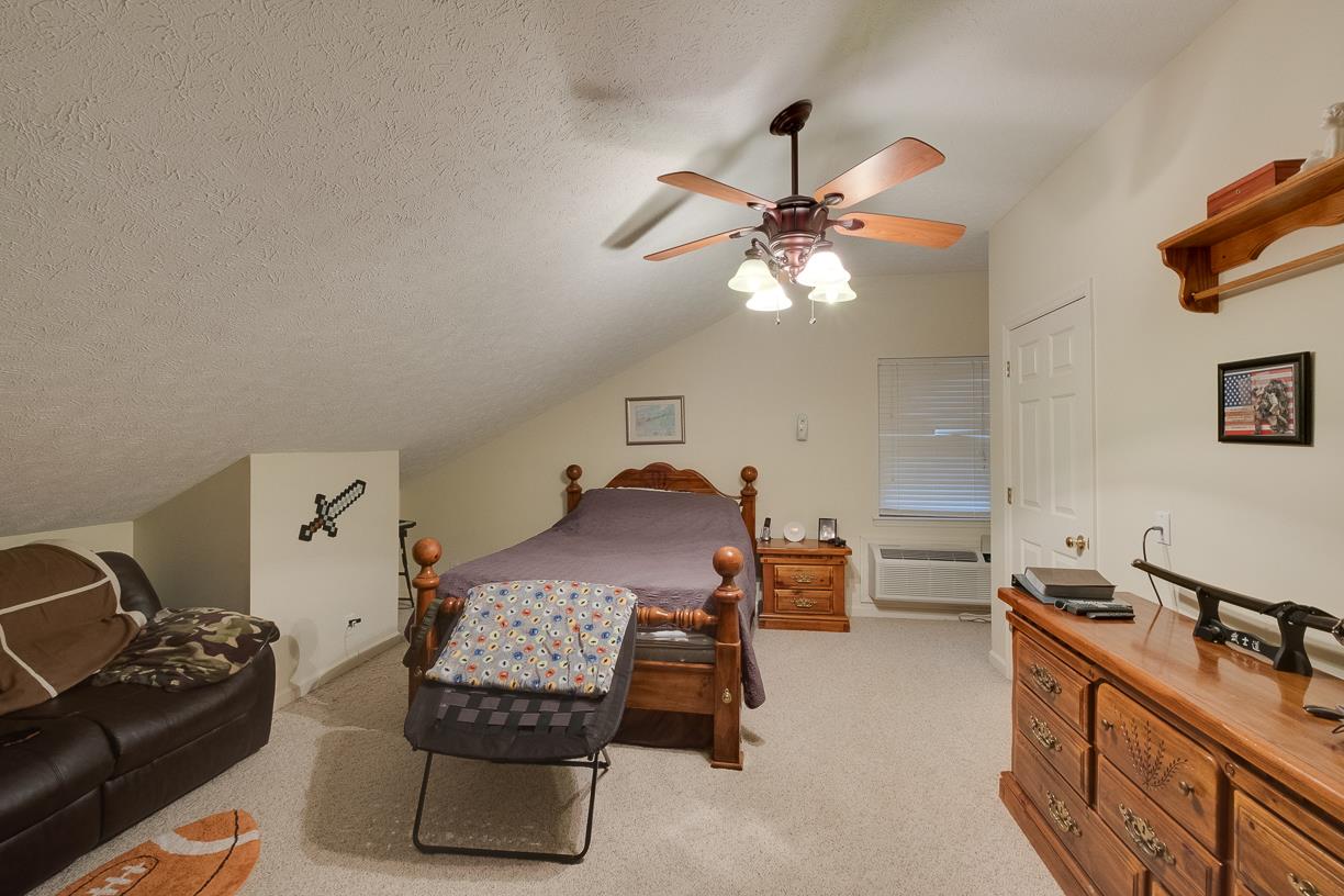 203 Link Road Cottontown, TN 37048 - Photo 22 of 30 a bedroom with furniture and a chandelier