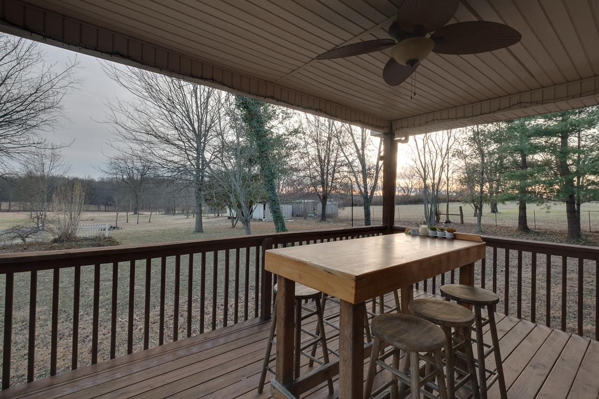 203 Link Road Cottontown, TN 37048 - Photo 24 of 30 a view of a patio with table and chairs with wooden floor and fence