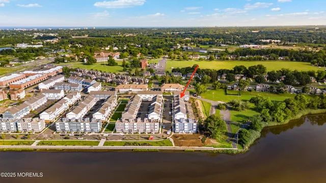 a view of a hallway with entryway and wooden floor