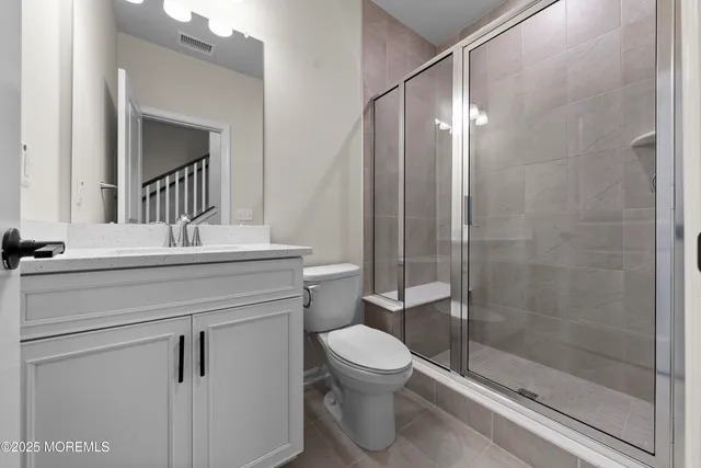 a large kitchen with stainless steel appliances granite countertop a refrigerator and a sink